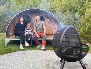 a family is sitting on a bench in a dome at Hikers & Bikers camp, Part of Preikestolen BaseCamp - Preikestolen trailhead in Jørpeland +17 photos