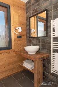 a bathroom with a sink and a mirror at Gîtes de Moyenmont in La Bresse +46 photos
