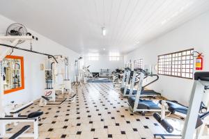 a gym with treadmills and machines in a room at Hotel Londri Star in Londrina