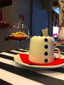 una taza de café sentada en un plato sobre una mesa en B&B Montecarlo en Palermo