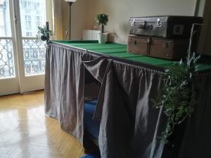a table with a table cloth and suitcases on it at Bauhaus Astoria Hostel in Budapest
