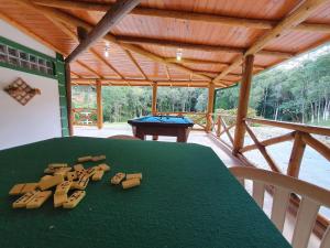 a room with a green table and a pool table at Sítio Pedacinho do Céu na Serra Catarinense in Rancho Queimado