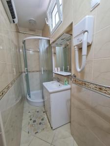 a bathroom with a shower and a sink and a mirror at Apartments NEF in Pinezici +74 photos