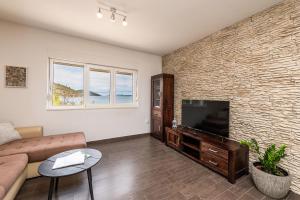 a living room with a couch and a flat screen tv at Apartment Anita in Savar