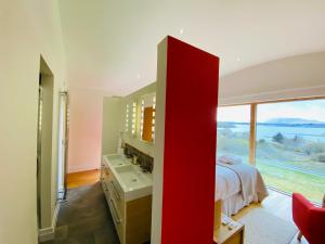 a bedroom with a bed and a large window at Ardtorna in Benderloch