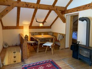 a dining room with a table and a wood stove at Kleine Ahornau in Schladming