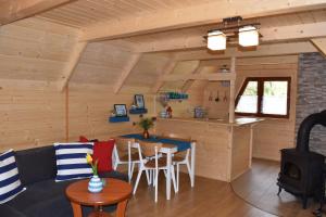 a living room and kitchen in a log cabin at Domek letniskowy in Sasino