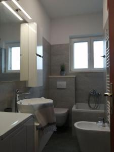 a bathroom with a sink and a toilet and a tub at Apartments Jelka in Postira