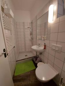 a small bathroom with a sink and a toilet at Apartma Viktorija in Portorož