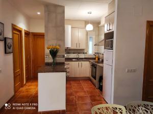 a kitchen with white cabinets and a counter top at Apartamento junto al mar in Les Cases d'Alcanar