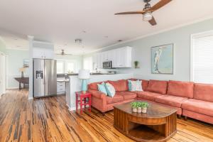 a living room with a couch and a table at Marsh Haven in Tybee Island