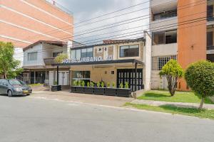 a building on a street with a car parked in front at Hotel Urbano 70 in Medellín