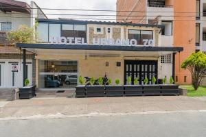 a hotel entrance with motorcycles parked outside of it at Hotel Urbano 70 in Medellín