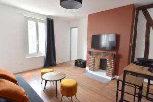 a living room with a fireplace and a tv at Welcome Home in Linas