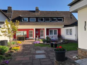 a home with a red and white house at Ferienwohnung Ratana in Bad Neuenahr-Ahrweiler
