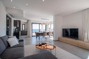 a living room with a couch and a tv at Villa Sea Silhouette in Žman