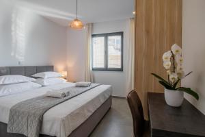a bedroom with a bed and a table with a vase of flowers at Villa Sea Silhouette in Žman +48 photos