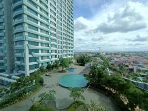 a view of a large apartment building and a swimming pool at Grand Kamala Lagoon By Mitra Propertindo in Bekasi