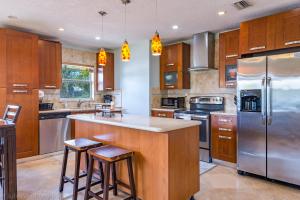a kitchen with wooden cabinets and stainless steel appliances at Highland Beach Retreat- Short walk to beach in Highland Beach