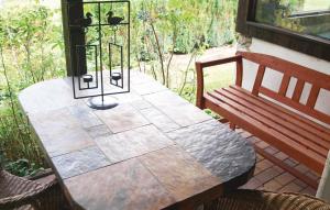 a wooden table and a bench on a patio at Beautiful Home In Zechin- Friedrichsaue With Kitchen in Friedrichsaue