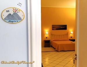 a hotel room with a bed and a room with at B&B Terra Mia Napoli in Naples