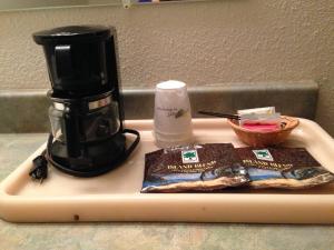 a coffee maker sitting on a cutting board at Redwood Inn in Crescent City