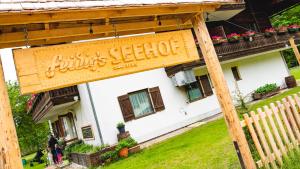 a sign for a fliths seetotide in front of a house at Seehof Feidig in Velden am Wörthersee