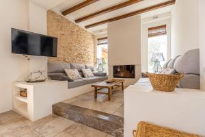 a living room with a couch and a fireplace at Villa Can Vicent in San Antonio