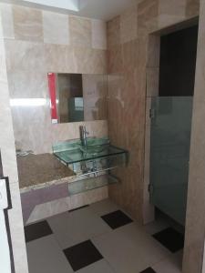 a bathroom with a green sink and a mirror at MOTEL SENA in Ensenada
