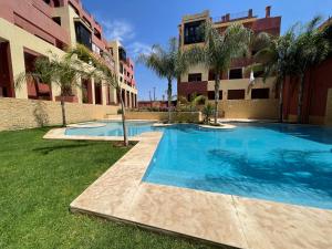 a swimming pool in front of a building at Chimera Apartments & Suites in Marrakech