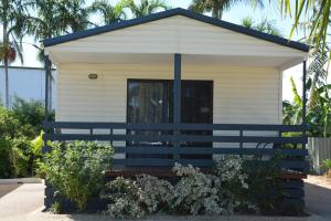 a small house with a blue bench in front of it at Southside Holiday Village in Rockhampton
