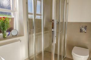 ein Bad mit Dusche, WC und Fenster in der Unterkunft Haus Hauke Whg 1 in Westerland