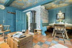 a living room with blue walls and a wood stove at Pidder Lueng 02 in Kampen