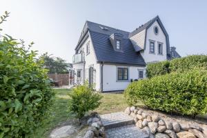 a white house with a black roof at Villa Aegir Whg 2 in Westerland