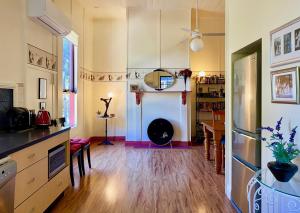 a kitchen with a table and a dining room at Eugenie Cottage 1930s Art Deco in Bright