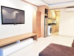 a living room with a flat screen tv on a wall at Sea view apartment Jomtien beach condominium 12th Floor in Jomtien Beach