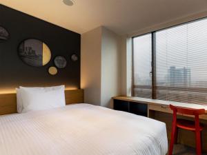 Postel nebo postele na pokoji v ubytování Granbell Hotel Osaka