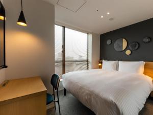 Postel nebo postele na pokoji v ubytování Granbell Hotel Osaka
