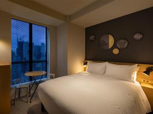 Postel nebo postele na pokoji v ubytování Granbell Hotel Osaka
