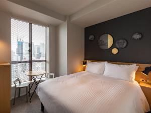 Postel nebo postele na pokoji v ubytování Granbell Hotel Osaka