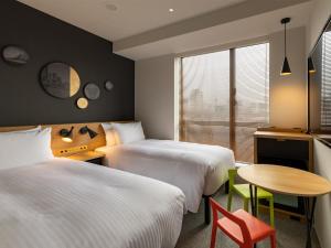 Postel nebo postele na pokoji v ubytování Granbell Hotel Osaka