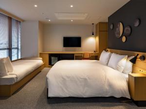 Postel nebo postele na pokoji v ubytování Granbell Hotel Osaka