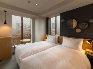 Postel nebo postele na pokoji v ubytování Granbell Hotel Osaka