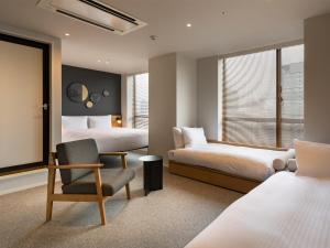 Postel nebo postele na pokoji v ubytování Granbell Hotel Osaka