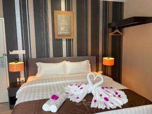 a hotel room with towels on a bed at Geo Boutique Hotel - Seri Kembangan in Seri Kembangan