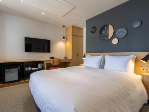 Postel nebo postele na pokoji v ubytování Granbell Hotel Osaka