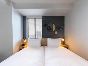 Postel nebo postele na pokoji v ubytování Granbell Hotel Osaka