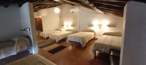 a room with four beds in a room at Albergue Turístico "San Blas" de Oliva de Plasencia in Oliva de Plasencia