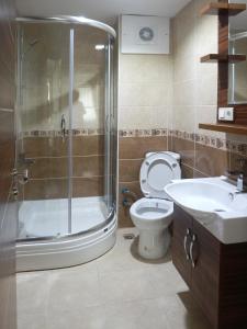 a bathroom with a shower and a toilet and a sink at New House in Istanbul