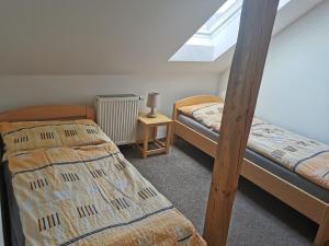 two bunk beds in a room with a window at Apartmány u Hastrmana in Vyšší Brod